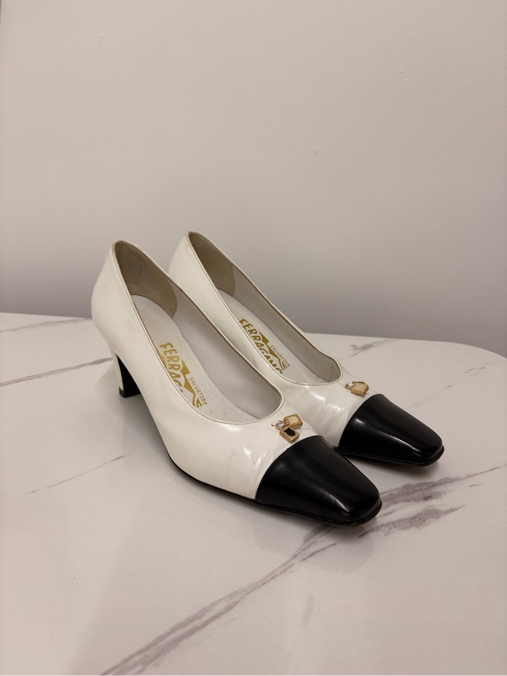 Salvatore Ferragamo White Leather Pumps with Black Cap Toe and Gold Buckle